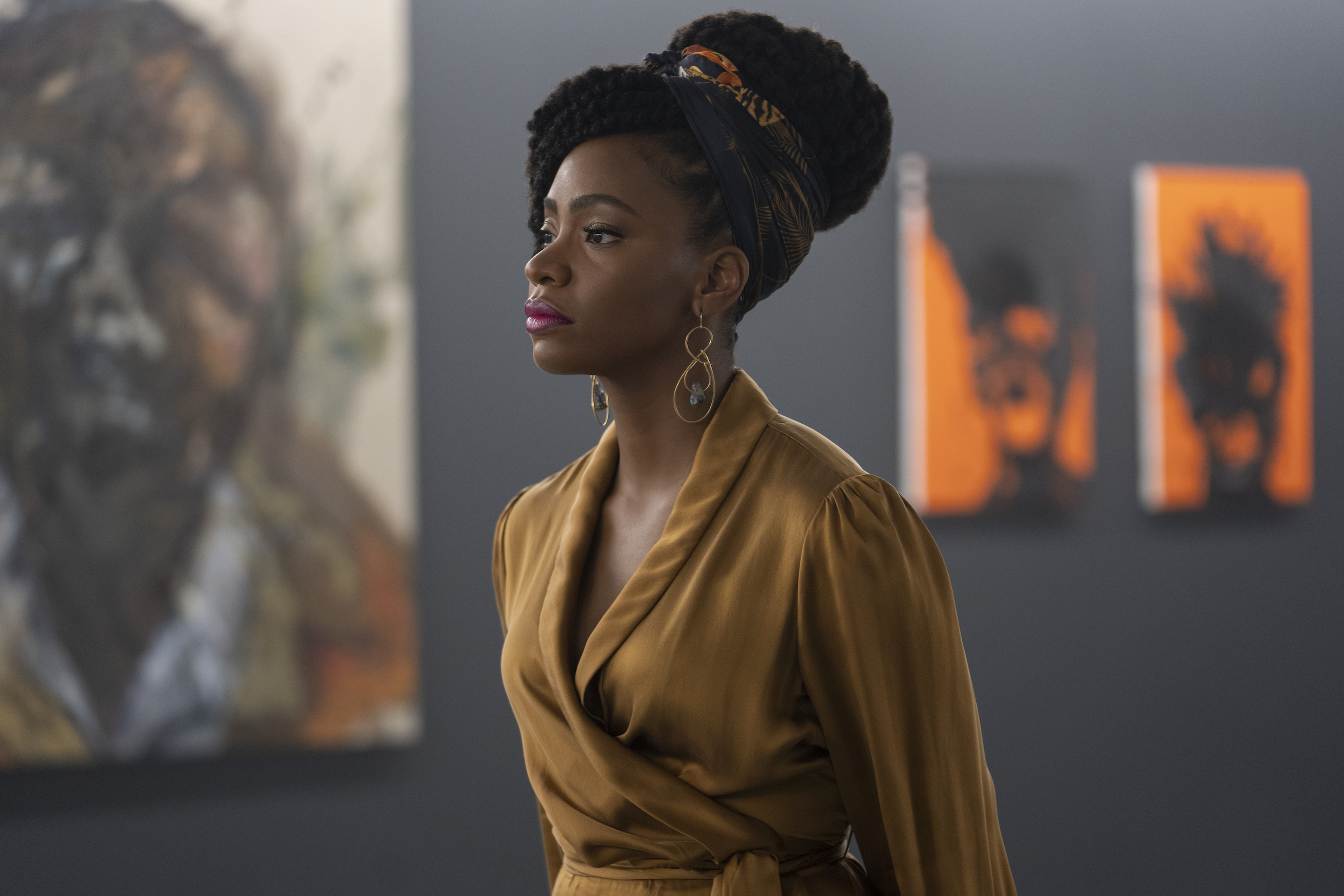 Teyonah Parris in the 2020 film Candyman in front of paintings.