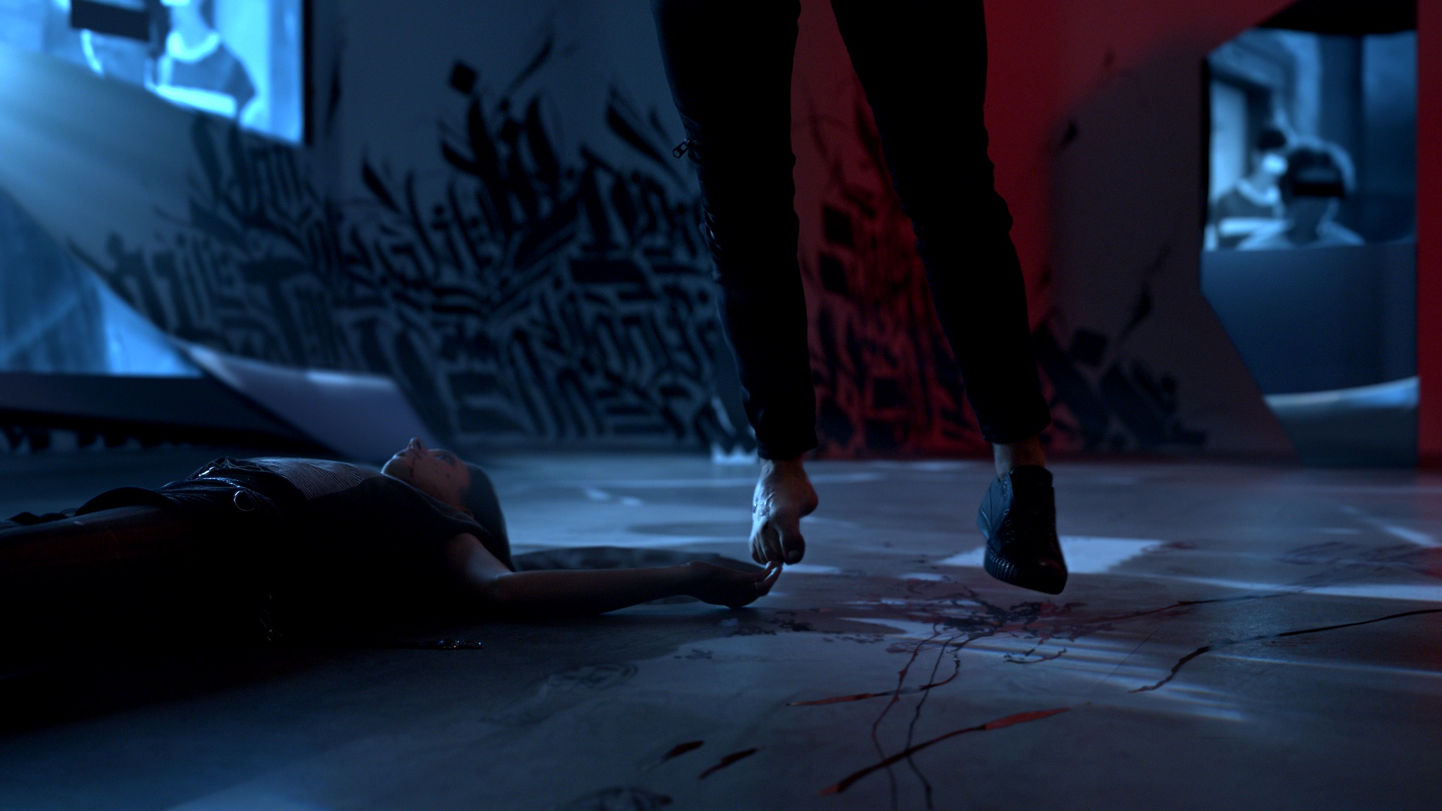 Scene from Candyman, a dead body laying on the ground in a pool of blood, next to feet floating off the ground.