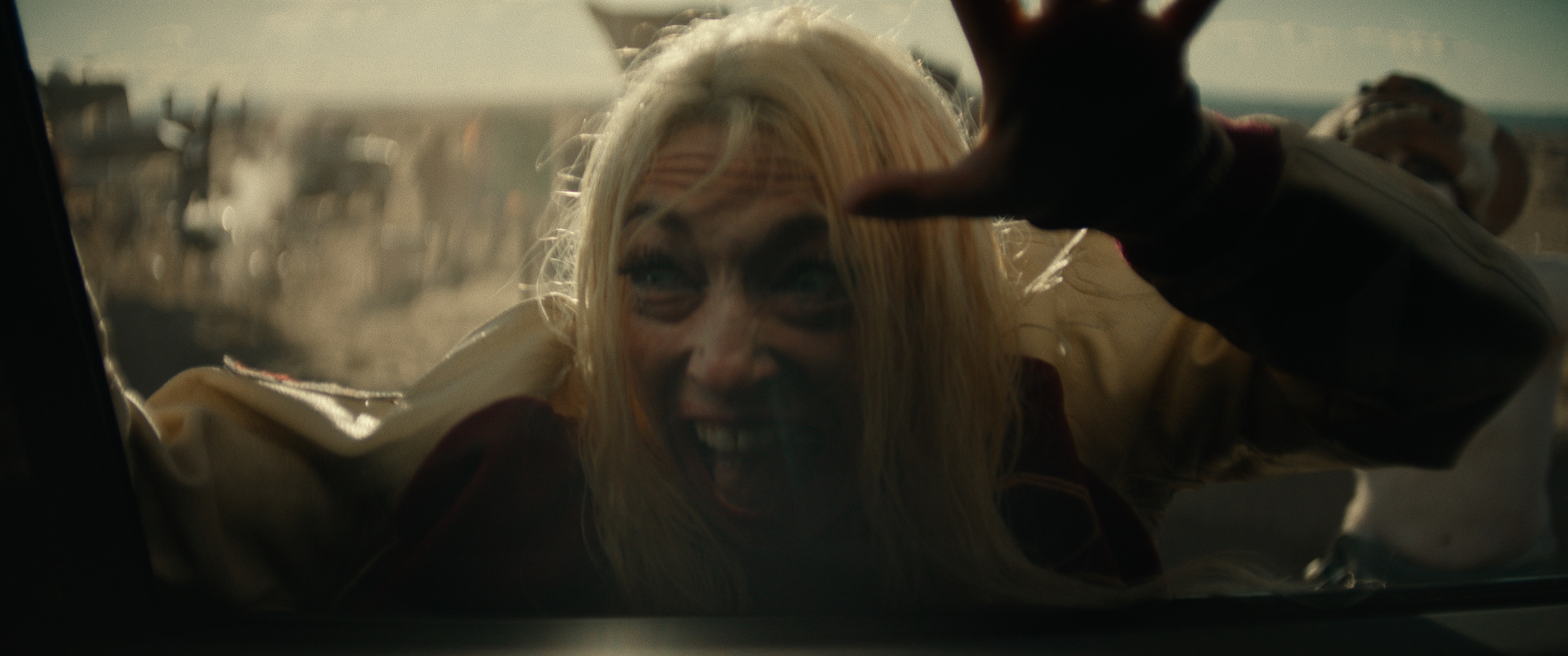A crazed Saviors fan presses her face against a window