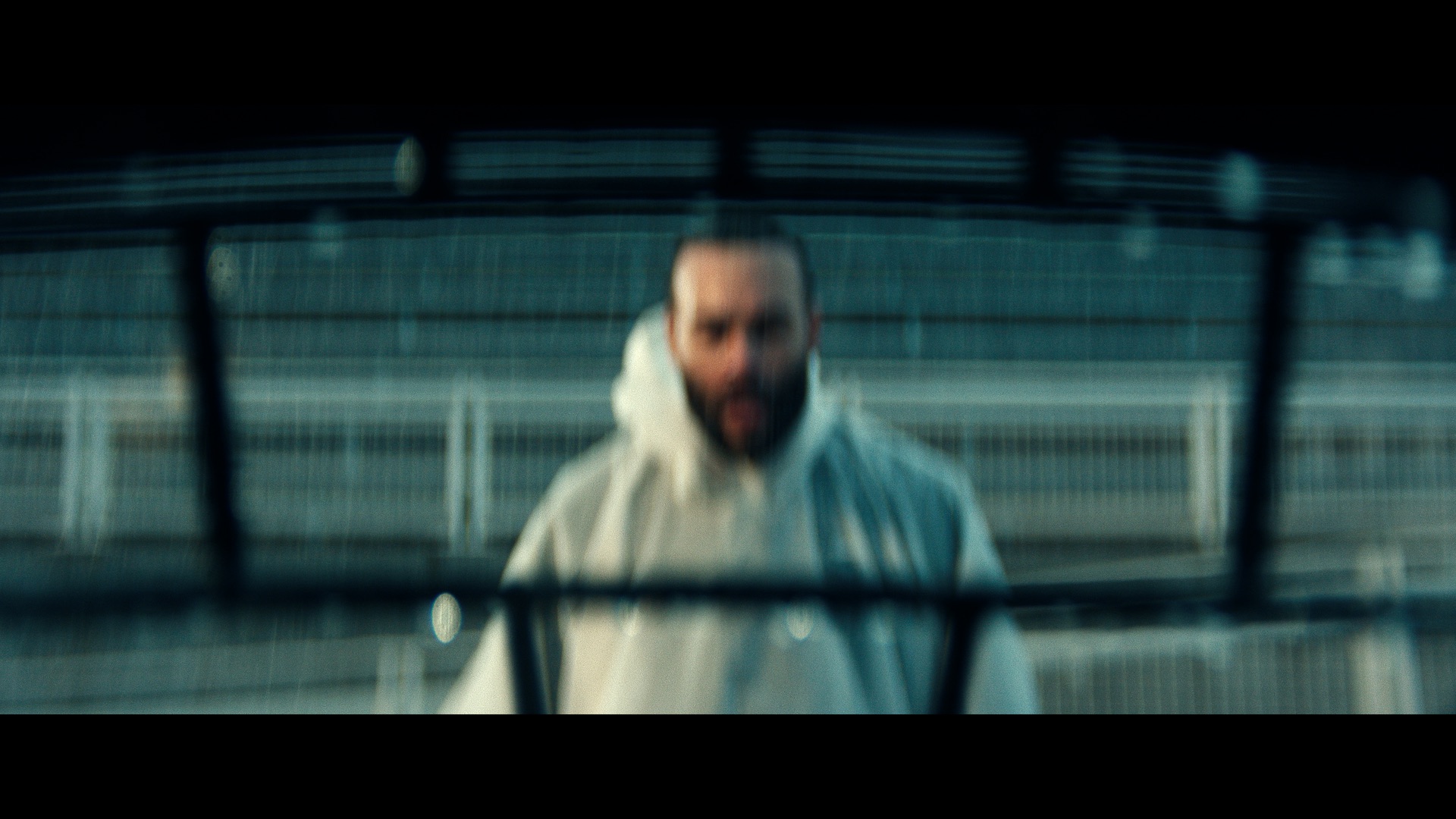 A blurry image of a man seen through a football helmet.