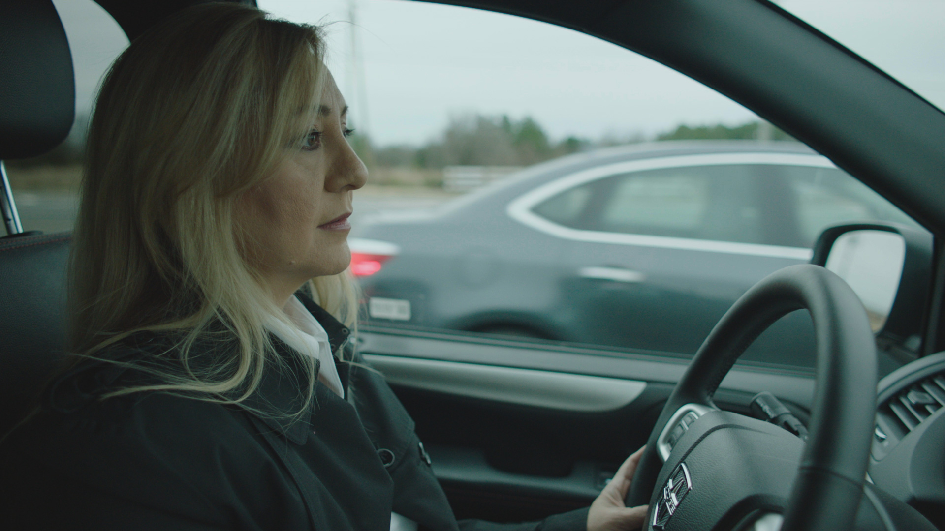 Lorena Bobbitt in the 2019 documentary series LORENA sitting in her car.