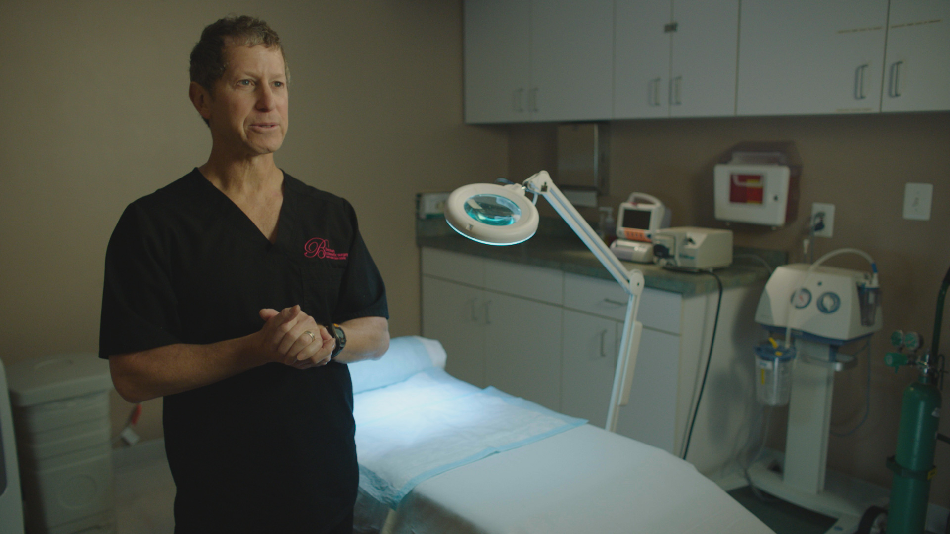 David Berman in the 2019 documentary series LORENA standing in doctor's office wearing scrubs.