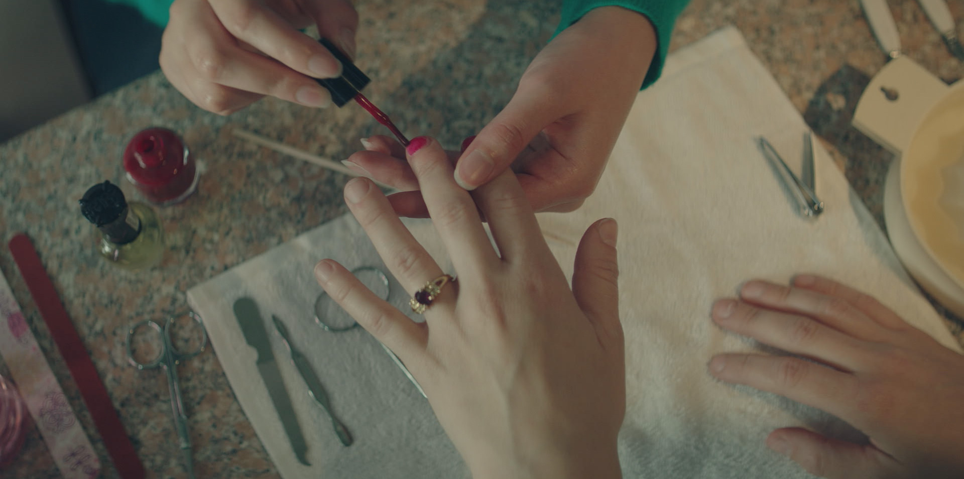 A manicurist in the 2019 documentary series LORENA painting the nails of a customer.