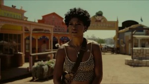 Scene from Nope: Keke Palmer standing outside in the middle of an the amusement park Jupiter's Claim.