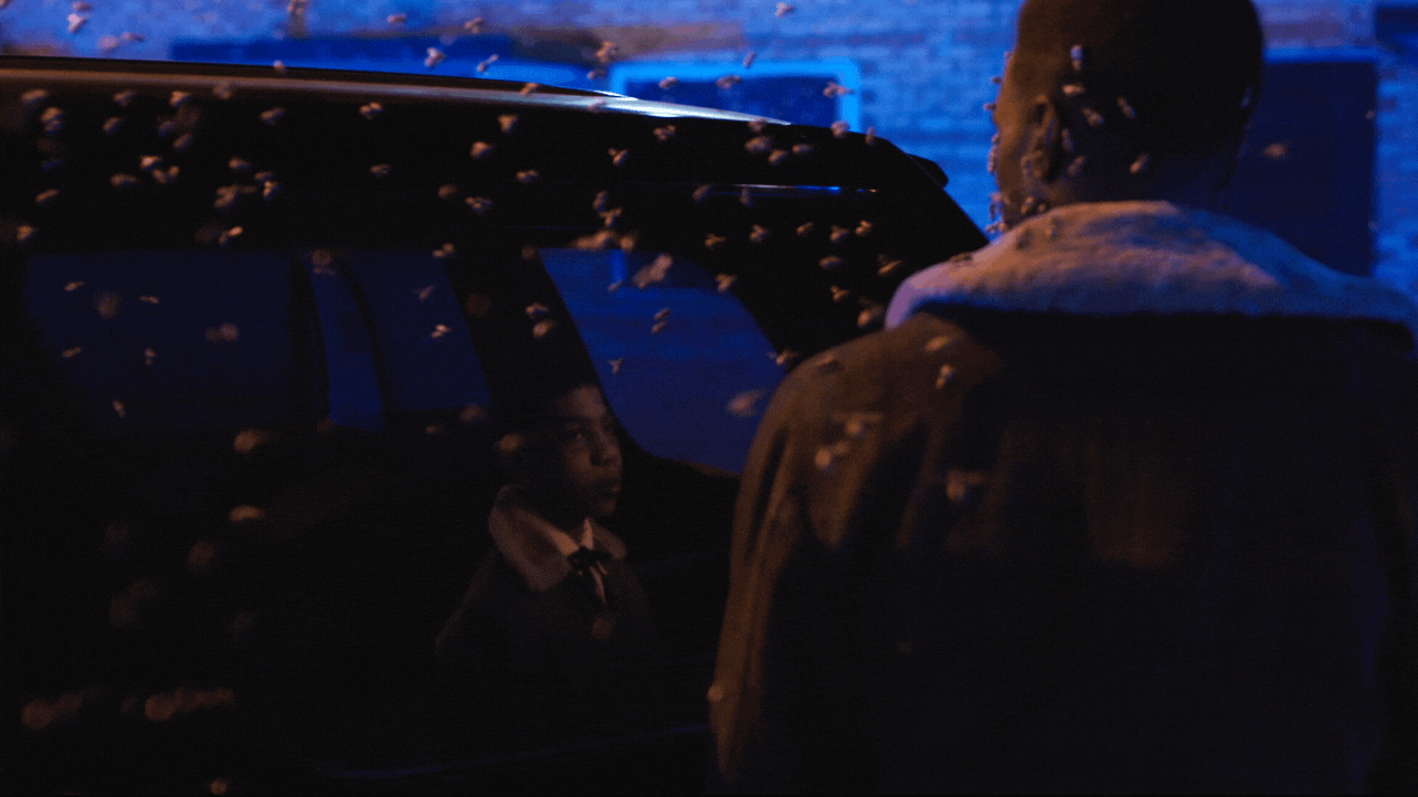 Gif of a scene in the Candyman movie, Candyman looking into car and seeing a reflection of himself as a boy, as he is swarmed by bees