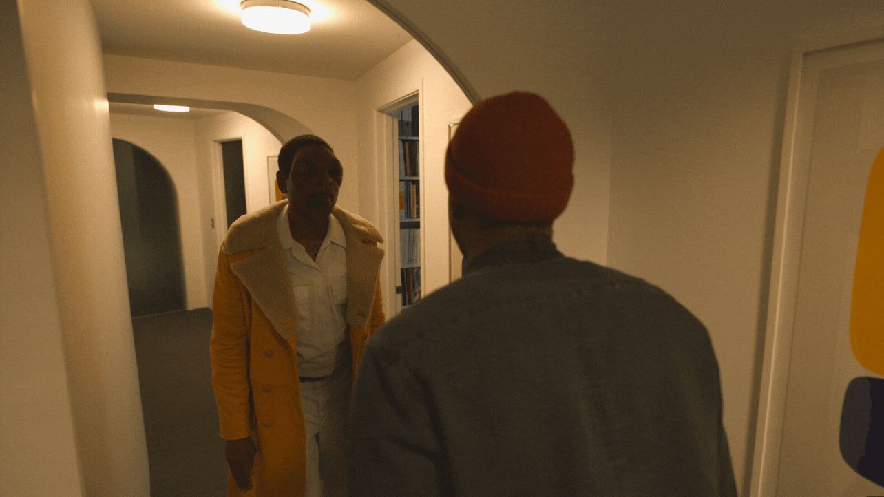 GIF of the main character in Candyman looking in the mirror to see a bloody deformed reflection of himself.