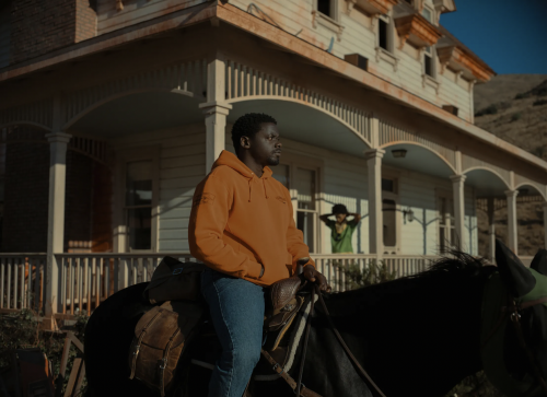 MJ Haywood sitting on horse in front of house in the movie NOPE.