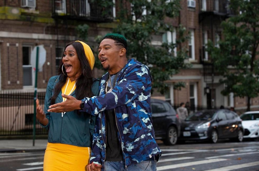 Diarra Kilpatrick and Allen Maldonado in the 2018 television series THE LAST O.G. standing in the street holding hands and gesturing.