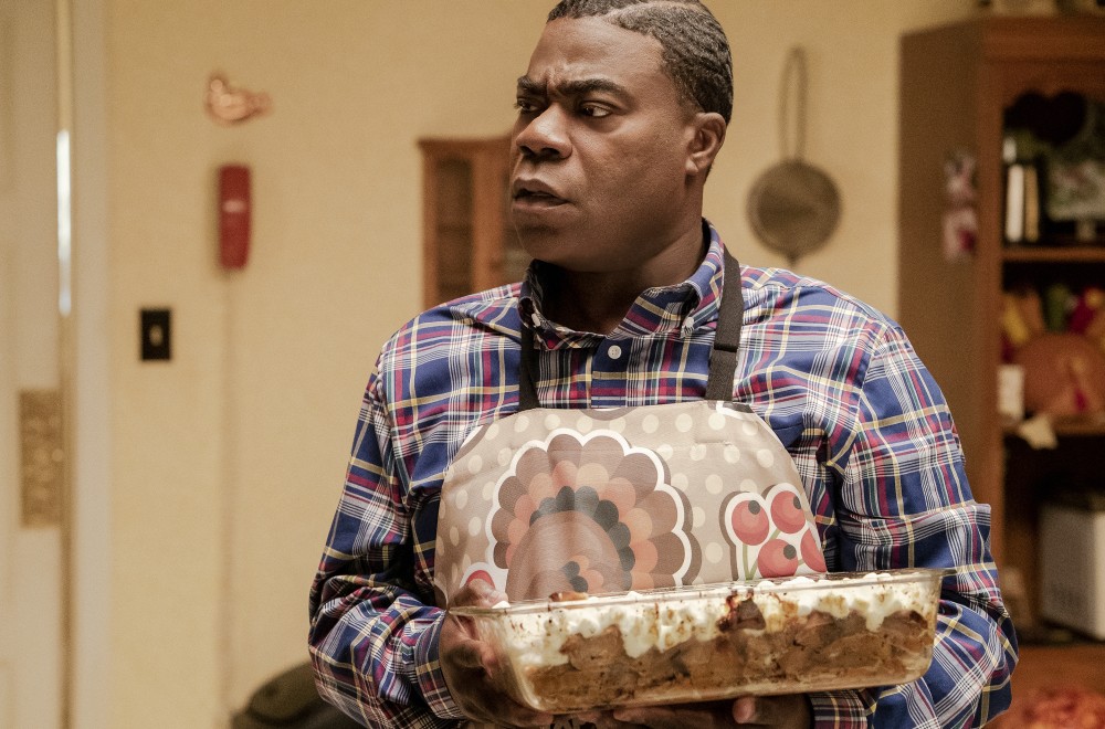 Tracy Morgan wearing a turkey apron while holding a baked dish in Season 1 of THE LAST O.G released in 2018.