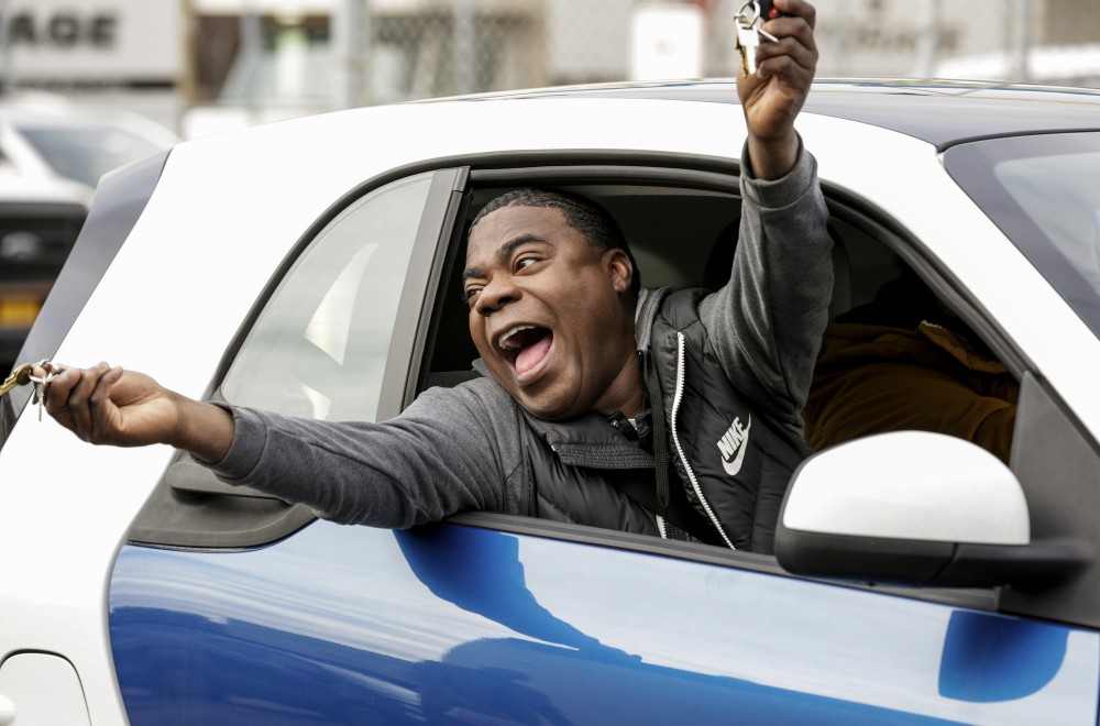 Tracy Morgan screaming in a car while his arms are extended out of the window in Season 1 of THE LAST O.G released in 2018.