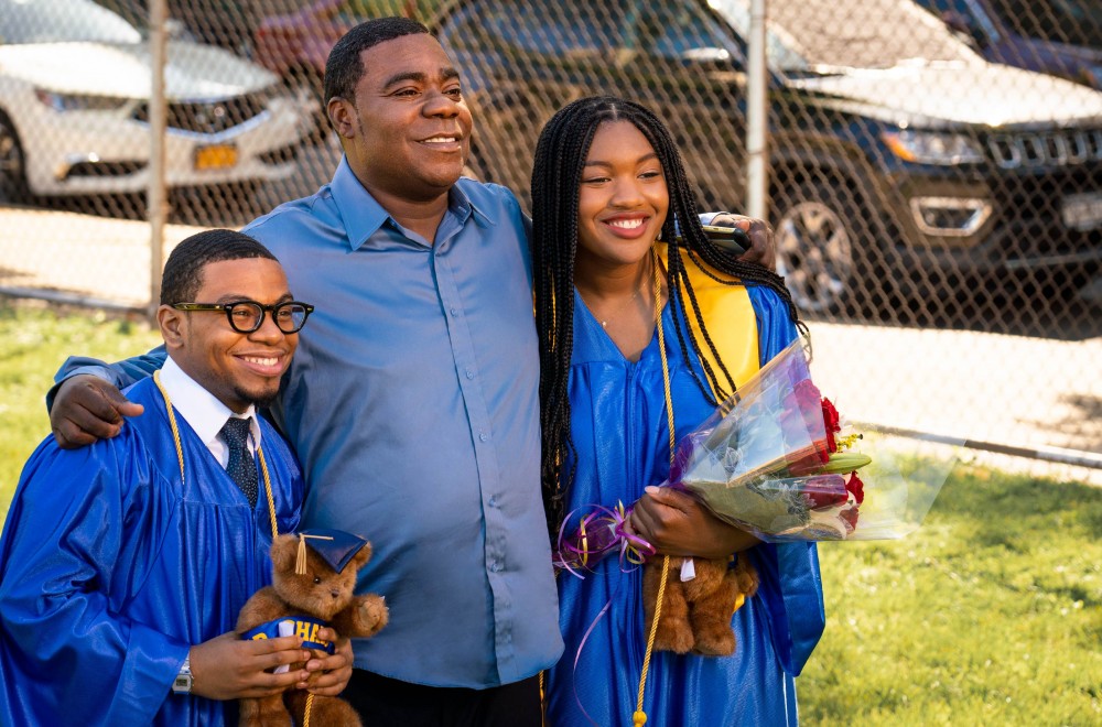 Two kids and a dad posing for a photo during graduation